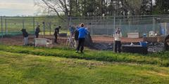 Volunteers clean up a yard at Canine Rescue of Central PA