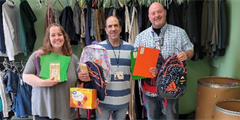 Staff stand with donations of school supplies.
