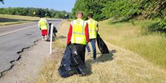 Three reentrants from York CCC pick up litter from along the road