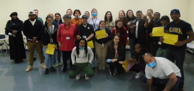 Students from Temple University and The Kintock Group stand in a group holding certificates after completing their Inside-Out Program