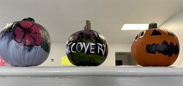Three painted pumpkins.