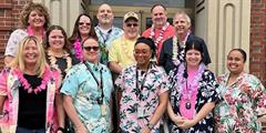 A group of people wearing Hawaiian shirts