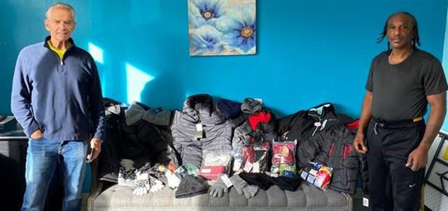 Two men stand by winter weather donations
