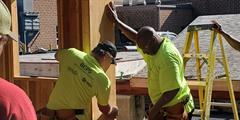 Two people work on a construction project