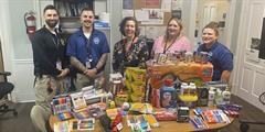 York CCC staff stand behind table of donated items.