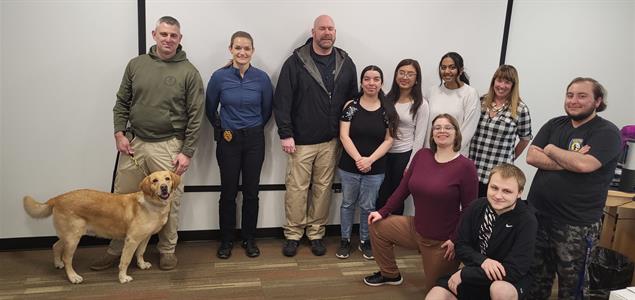Three DOC employees stand with their K9 and 7 people from Penn State Hazleton