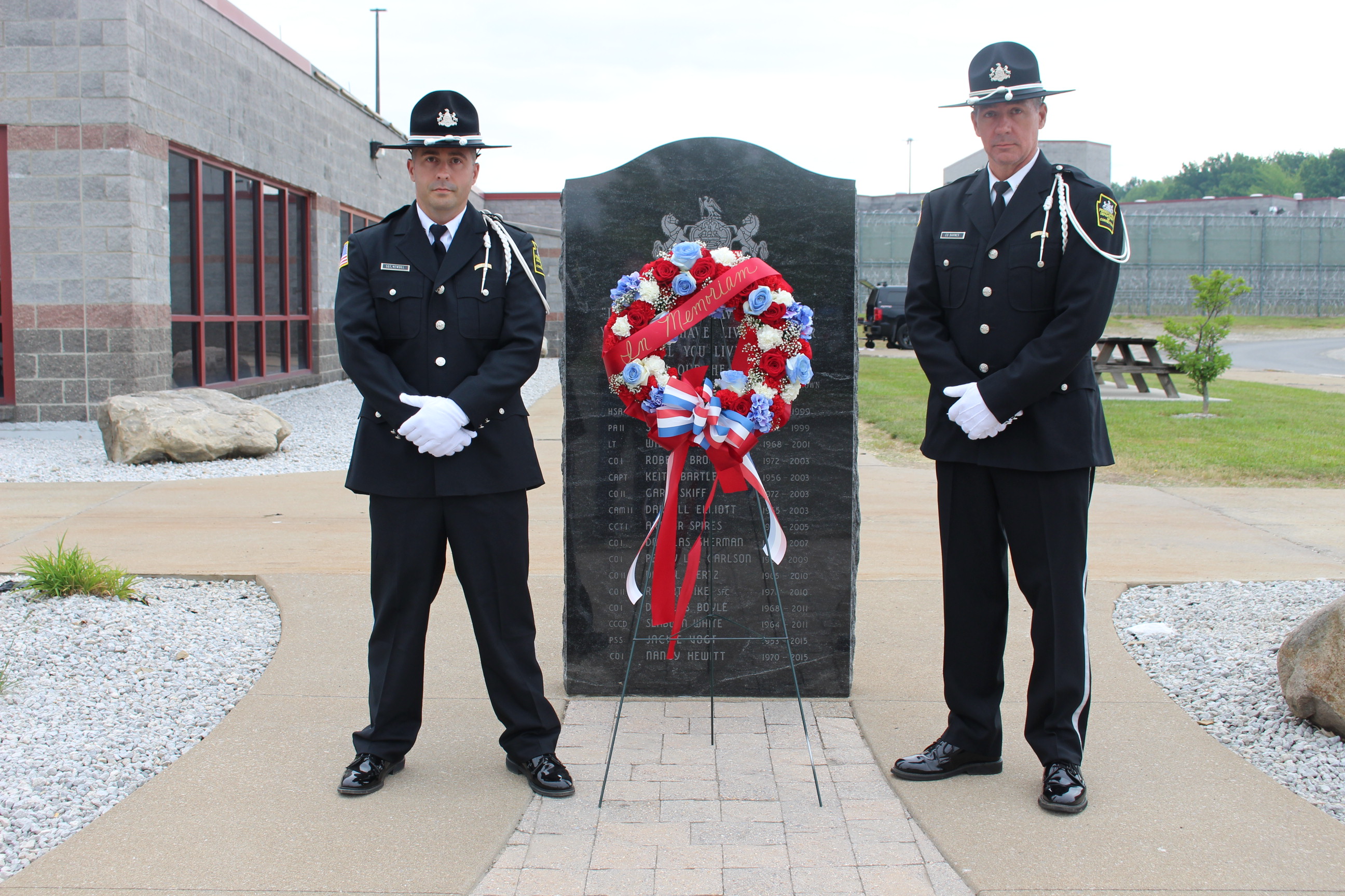 Two members of the SCI Albion Honor Guard stand at the Albion Memorial.