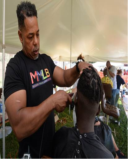 Michael Hooks cutting a man's hair