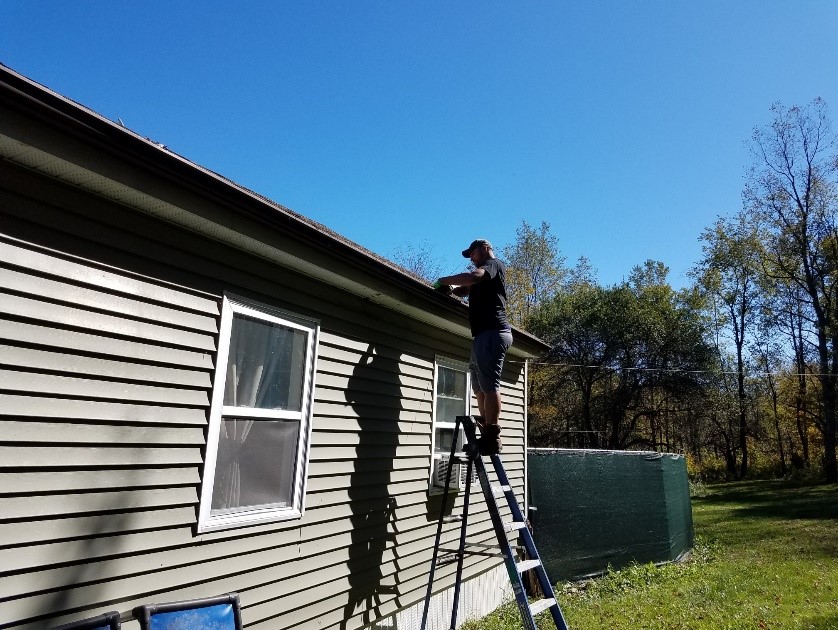 A man repairs a roof