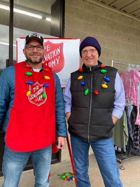 Two people ringing the bell for the Salvation Army