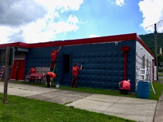 Inmates paint a community building