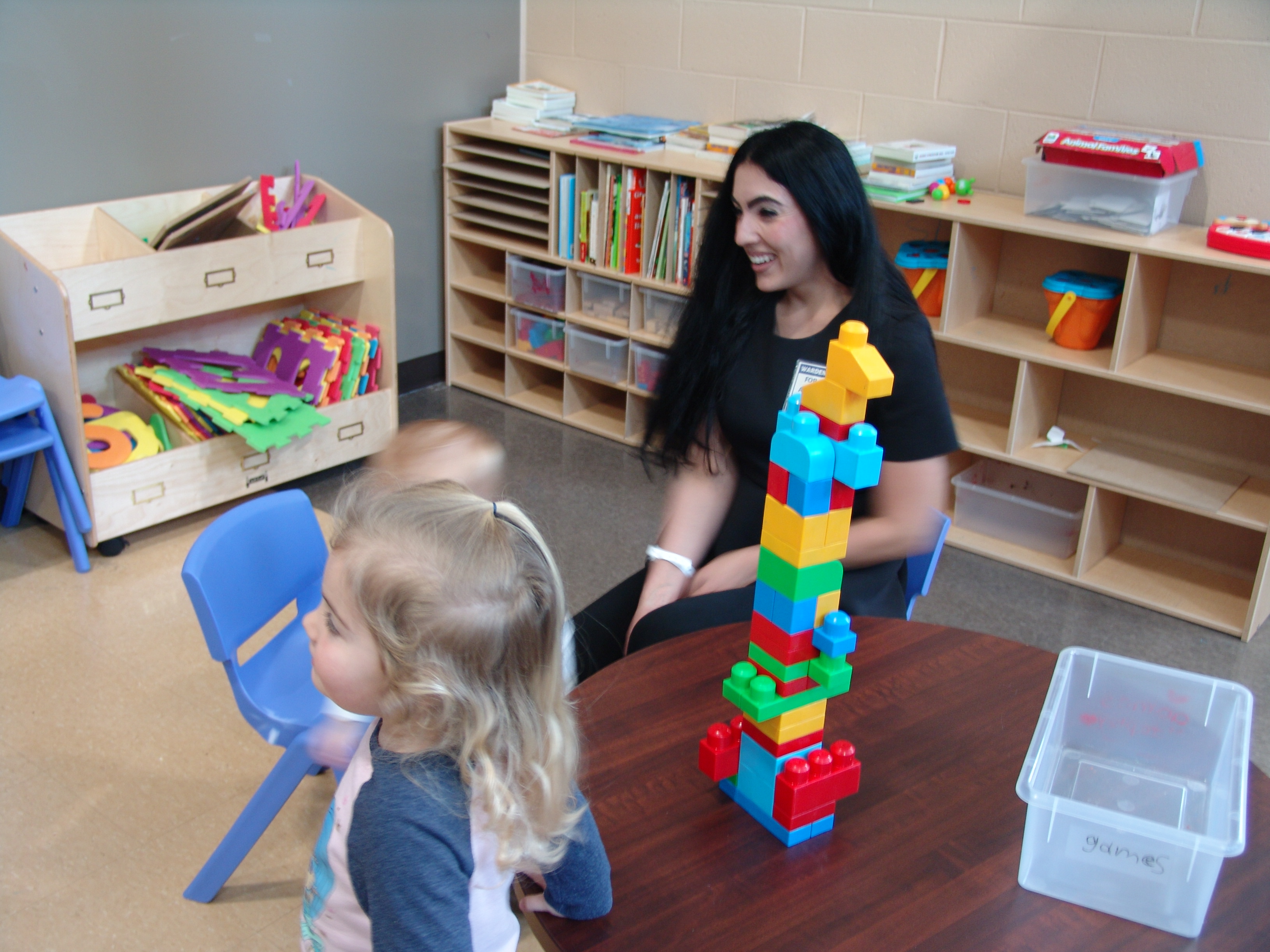 Second Lady Gisele Fetterman plays with two children in the SCI Phoenix visiting room