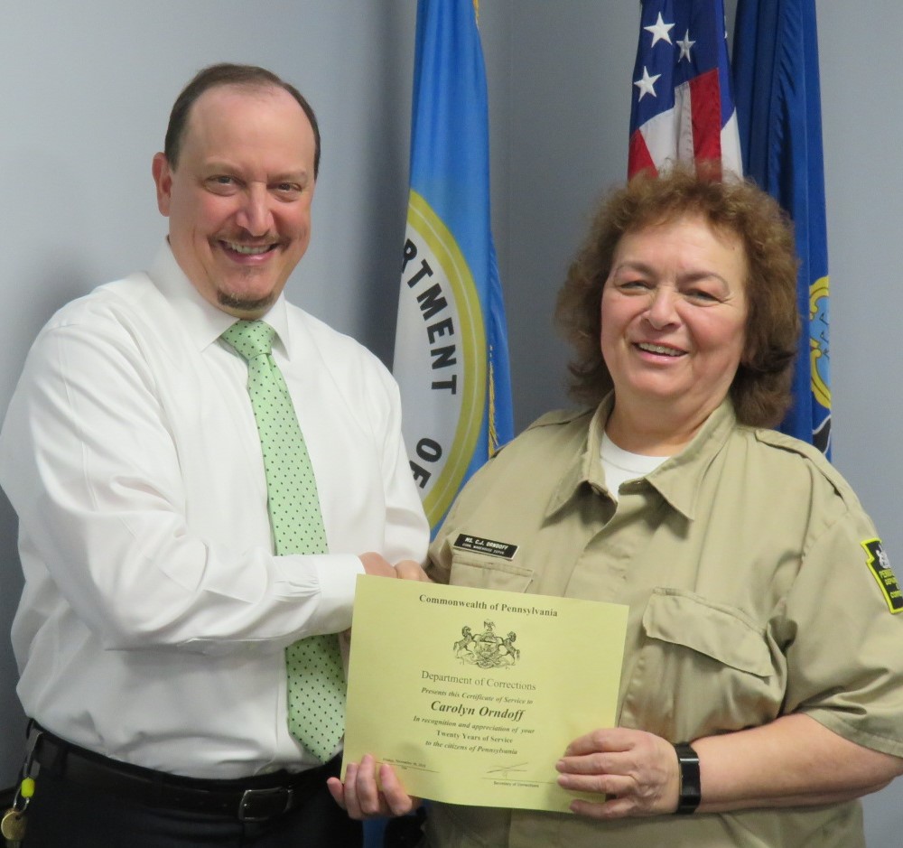 Superintendent Robert Gilmore presents Carolyn Orndoff a certificate