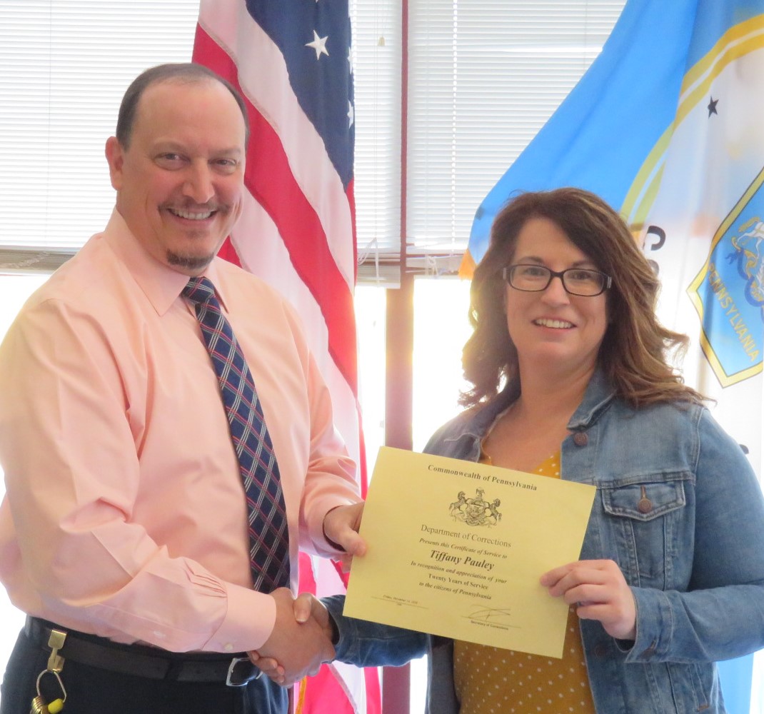 Superintendent Robert Gilmore presents Tiffany Pauley a certificate