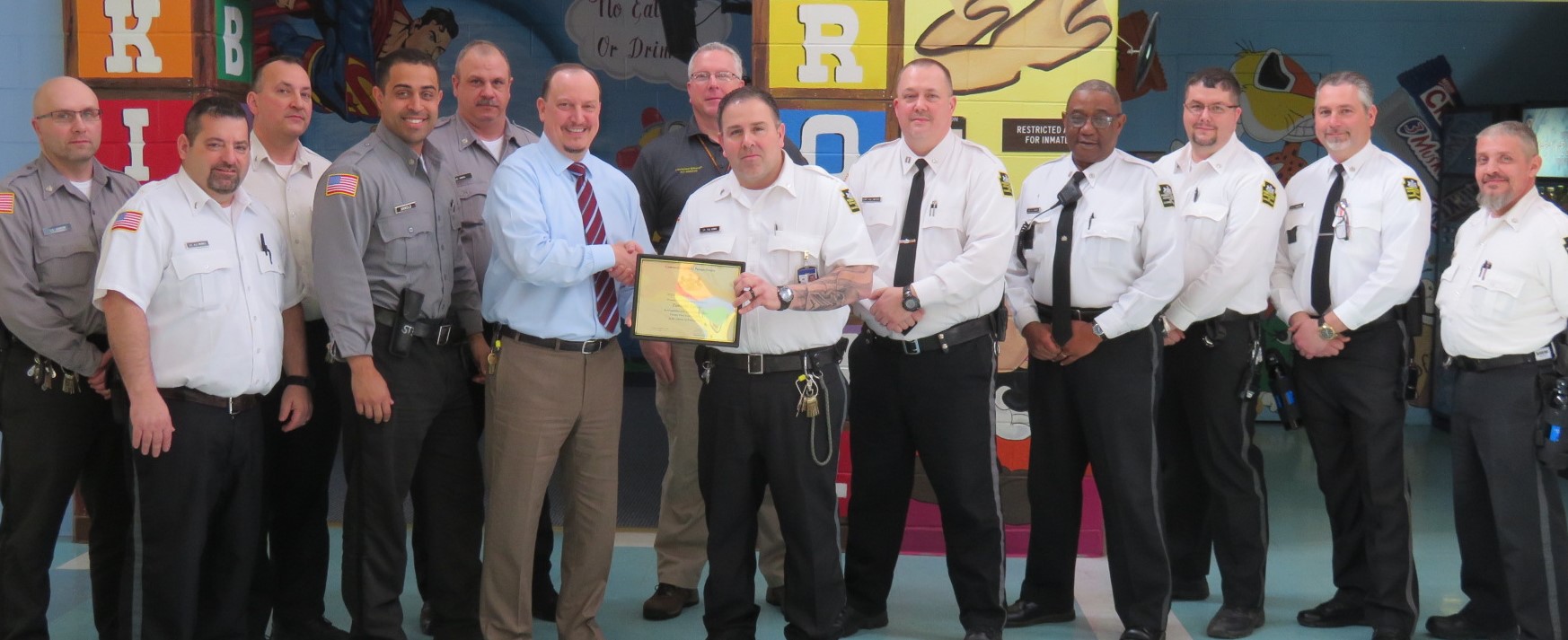 Lieutenant Tim Lewis with colleagues and his retirement certificate