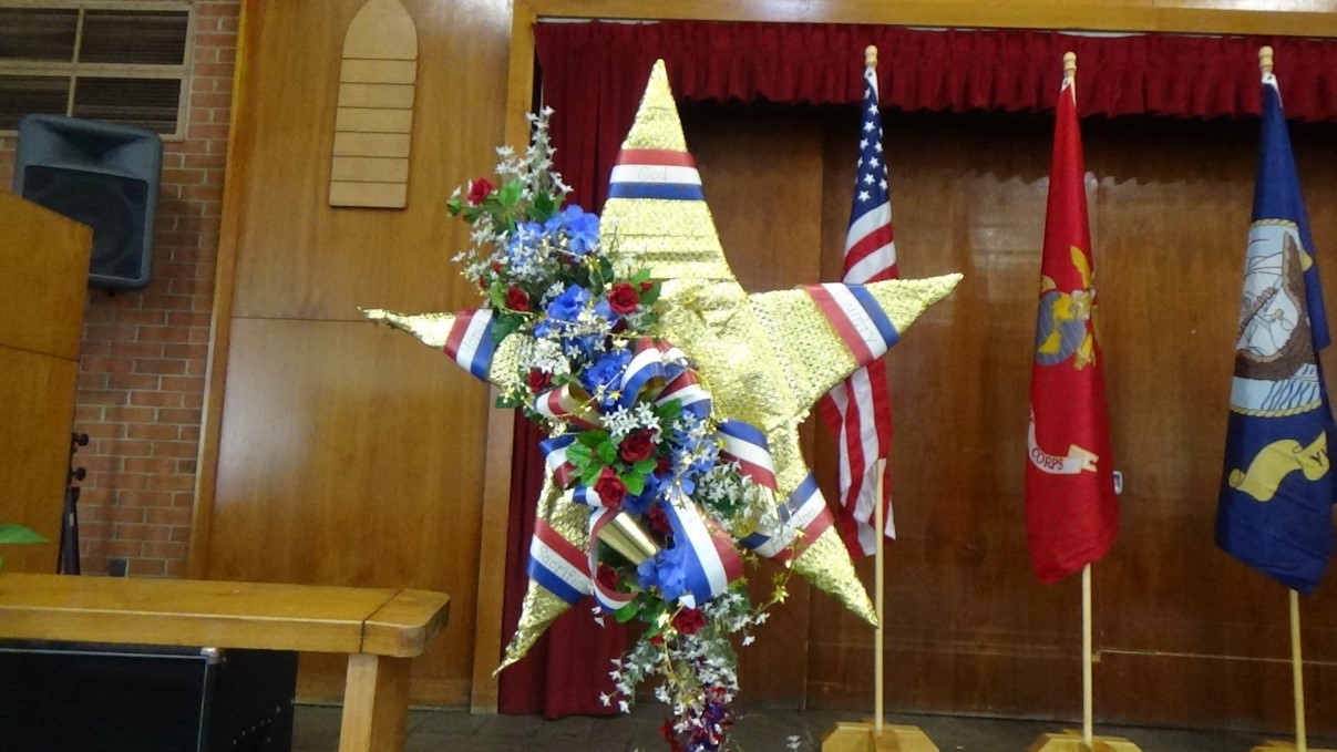A gold star in front of flags