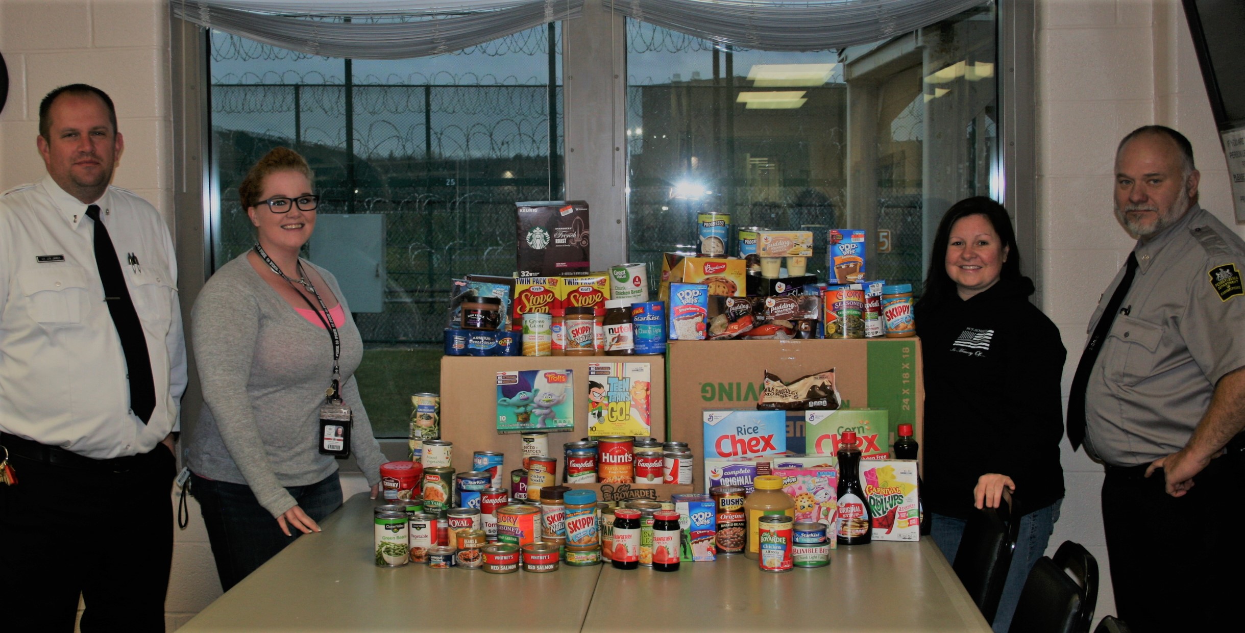 SCI Houtzdale staff stand with items they donated to a food bank