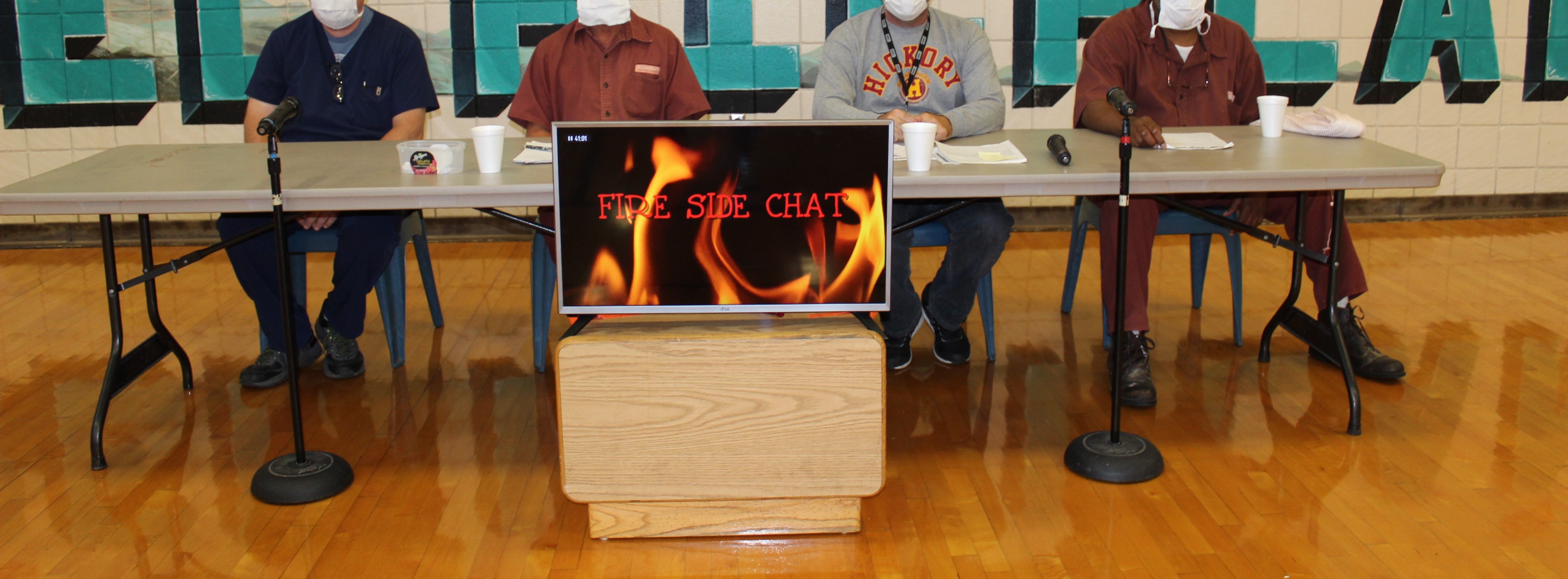 A panel sits for a Fireside Chat