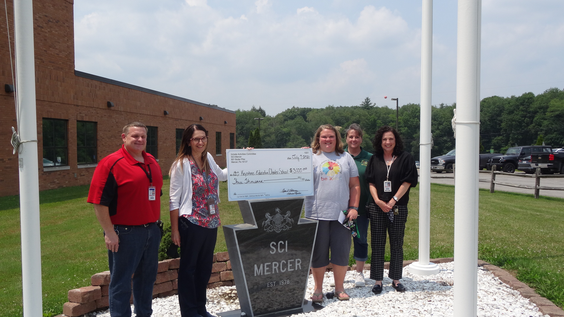 SCI Mercer staff present Keystone Education Center staff with a check