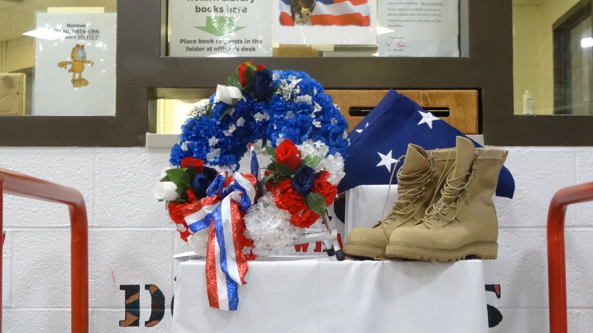 A memorial featuring a wreath and boots in a memorial day service