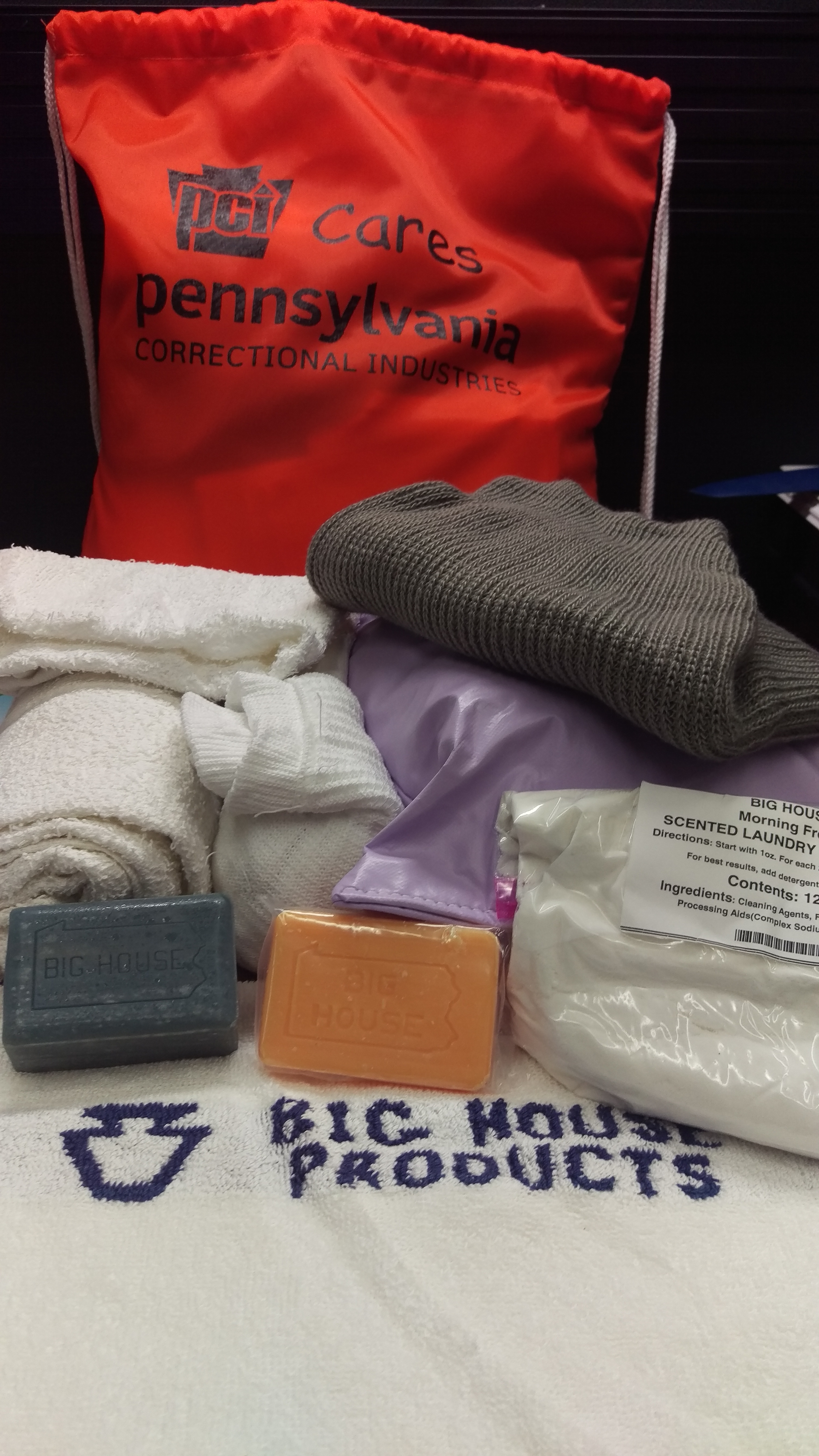 Assorted items made by Pennsylvania Correctional Industries, including towels, soap and a bag.