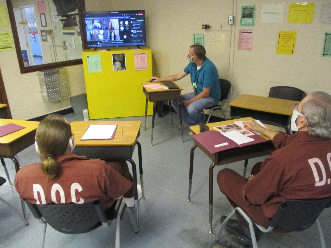 Inmates watch a virtual presentation