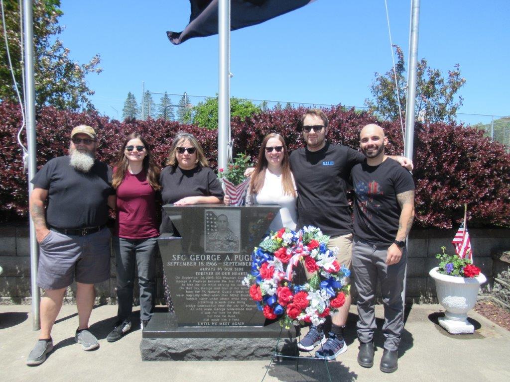 The Pugliese family stands at the SFC George Pugliese Memorial Site outside SCI Waymart