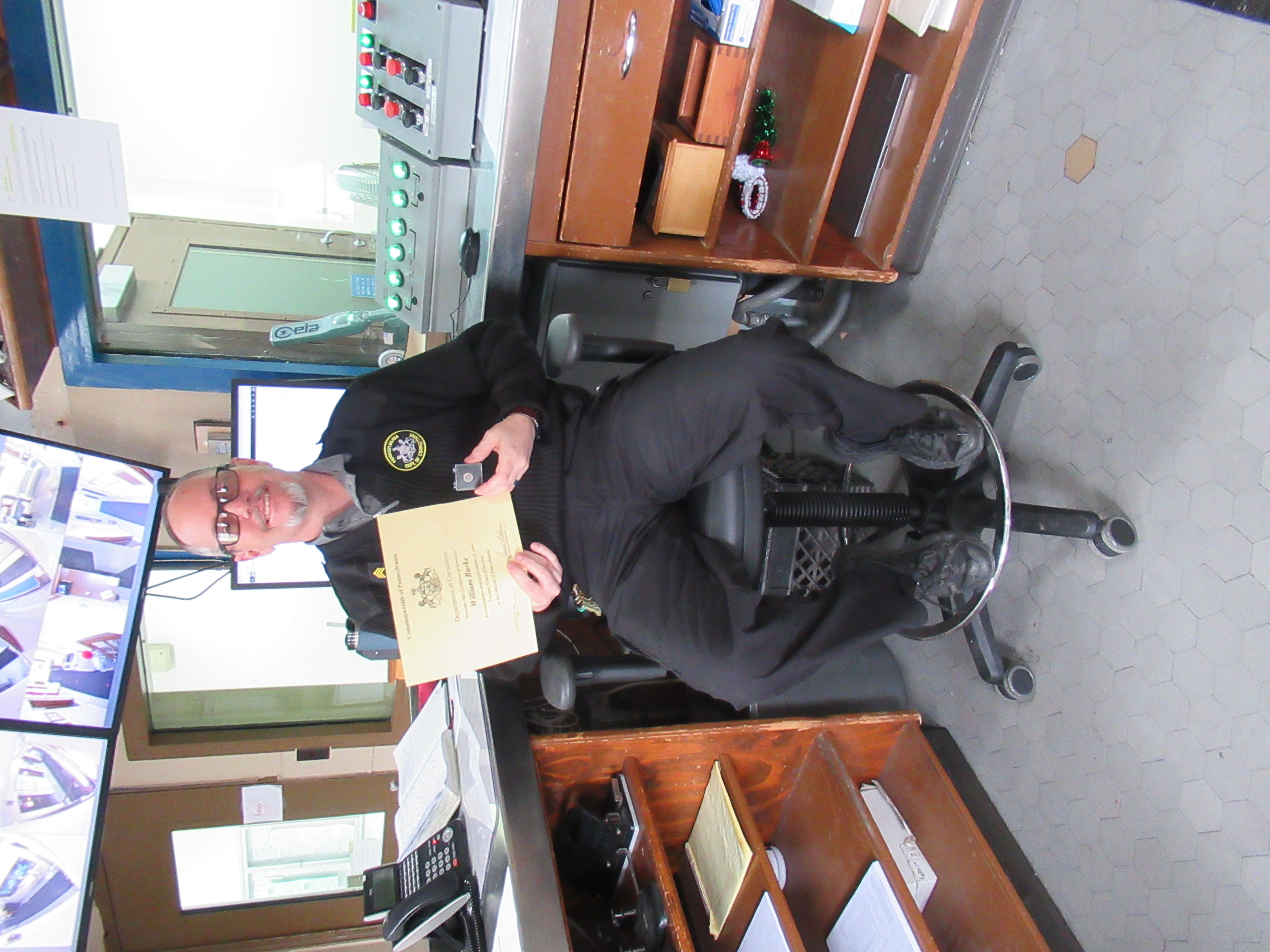 Sgt. William Burke holding a certificate.