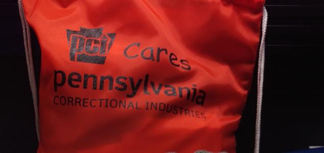 A bag that says "PCI Cares; Pennsylvania Correctional Industries."