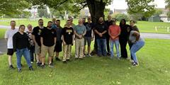 Allentown District Office parole employees stand together under a tree.