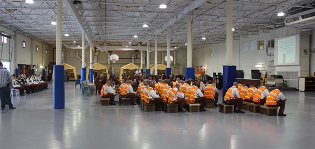 The Quehanna Boot Camp population sits in a big warehouse watching a presentation