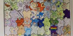 A poster of jigsaw pieces forming a quilt with messages of encouragement on it