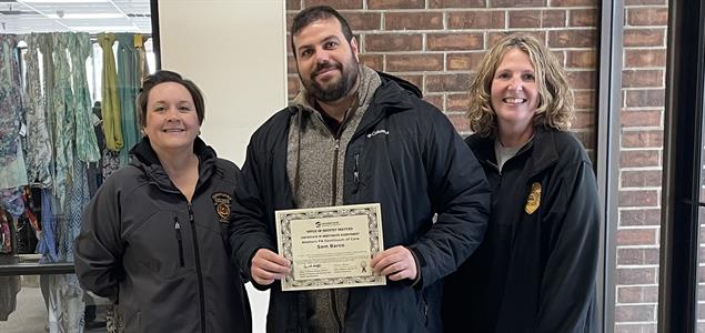 Reentry Parole Agent Marnie Sommers and Parole Agent Kaylene Carson stand with Sam Barco of the Forensic Boundary Spanner program as he holds his certificate of appreciation