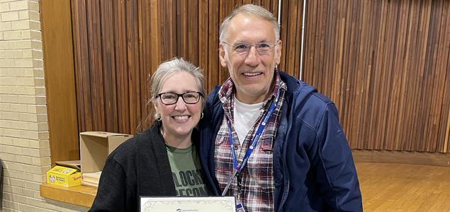 Regional Institutional Parole Director Jennifer Hammond and Deputy Secretary for Office of Reentry Michael Wenerowicz stand together with a certificate.