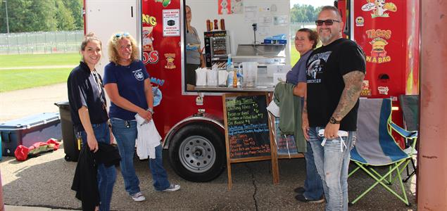 SCI Albion employees stand outside a food truck