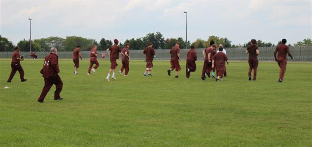 SCI Albion inmates run in a field