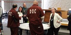 Two inmates talk to DOC staff