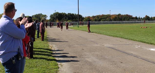Staff cheer as inmates run in a race