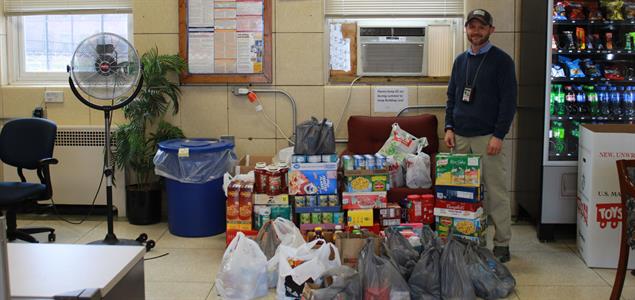 A man standing with donated food
