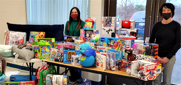 People standing with donated toys