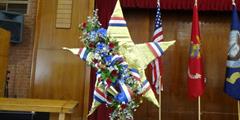 A gold star in a patriotic wreath