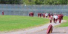 SCI Dallas inmates walk along their track