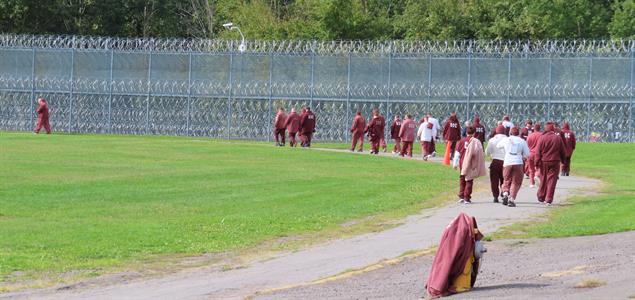SCI Dallas inmates walk along their track