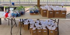 Gift bags and plants for attendees at SCI Dallas' retiree cookout