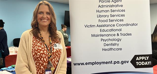 SCI Dallas Correctional Health Care Administrator Gola stands at her booth at a recent career fair.