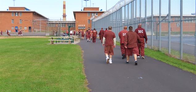 Incarcerated individuals at SCI Dallas walk around the track.