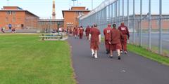 Incarcerated individuals at SCI Dallas walk around the track.