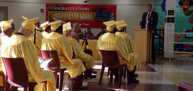 SCI Fayette graduates sit and listen to a guest speaker during their graduation ceremony.