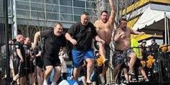 Four SCI Fayette employees jump into a cold pool during a Polar Plunge.