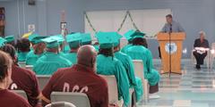 Inmates watch a speaker at their graduation ceremony at SCI Greene